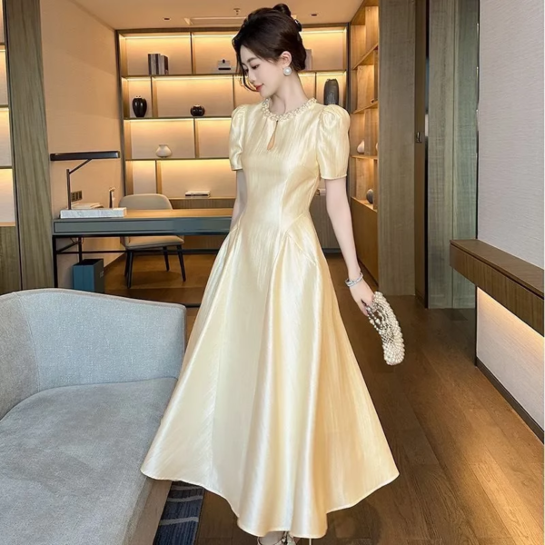 Tea break long skirt 2025 summer new women's French style round neck waist draped over-knee dress